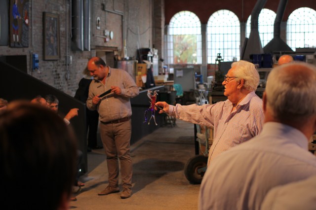 Holding up the final and totally amazing product! He also made a beautiful vase