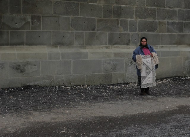 A local woman selling her needlepoint outside the church