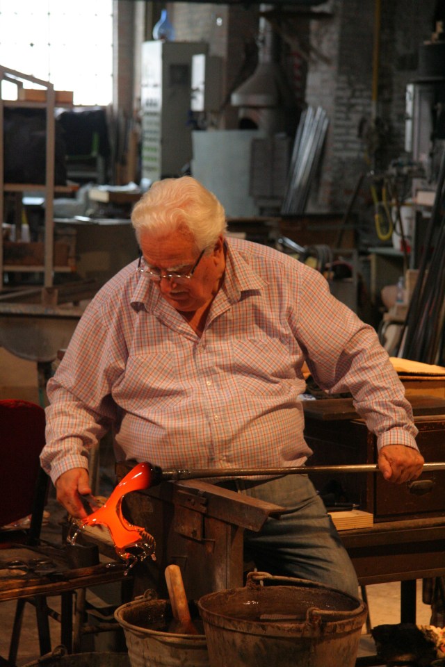 One of the artisans creating a horse from a hot piece of glass